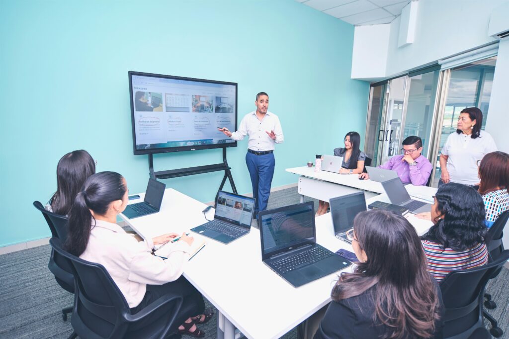 pexels photo 34221175 34221175 Team engaged in a presentation at a modern office using digital technology.